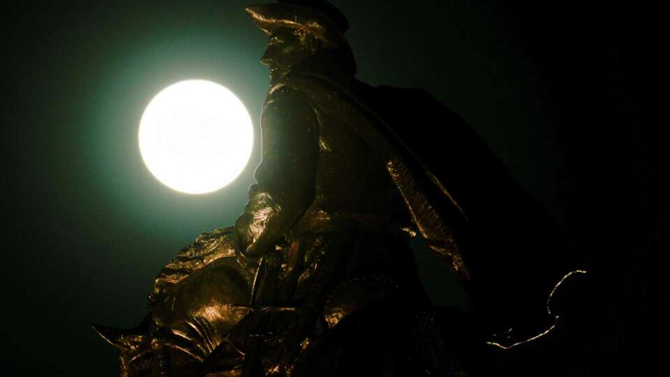 A blue supermoon rises behind the Sam Houston Monument near Hermann Park, Wednesday, Aug. 30, 2023, in Houston. A blue moon is when a month has two full moons. The moon appeared especially big and bright because it's closer to Earth than usual.