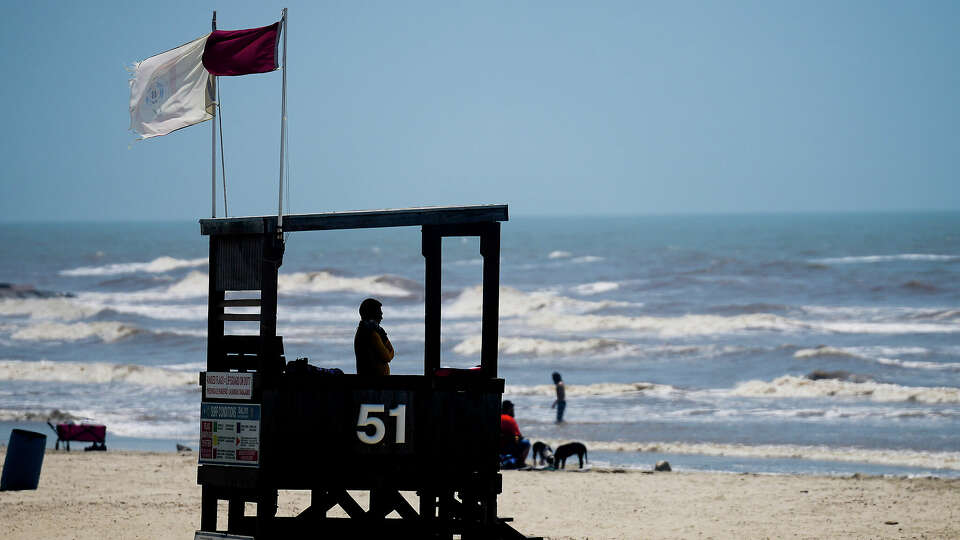 A lifeguard watches swimmers on Friday, June 16, 2023 in Galveston.