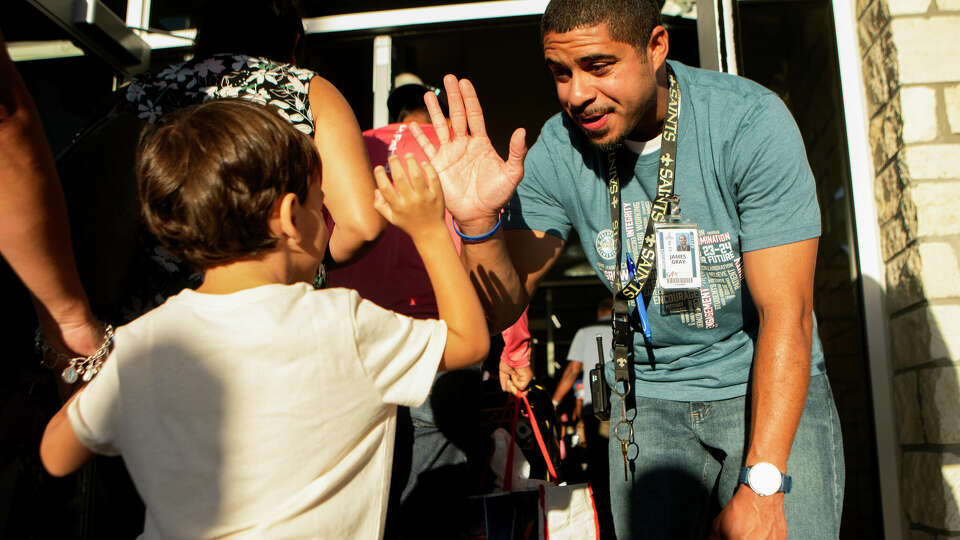 James Gray, assistant principal at Russell and Cindy Fallen Elementary, greets students with high-fives and well wishes on the first day of school for Katy ISD, Wednesday, Aug. 16, 2023, in Katy.