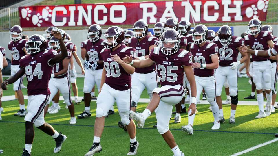 Cinco Ranch players warm up before a non-district high school football game at Legacy Stadium, Thursday, Aug. 31, 2023, in Katy.