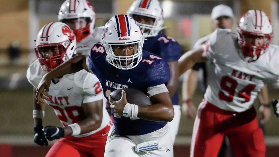 Atascocita running back Cardae Mack (14) makes a gain in front of Katy defenders during the second half of their non-district football game held at Turner Stadium Friday, Sep. 1, 2023 in Humble, TX.