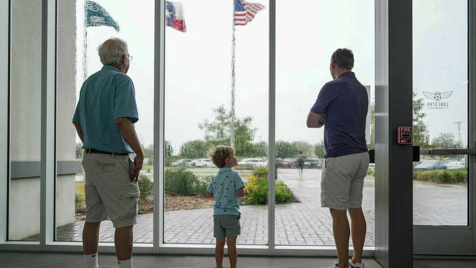 People wait out the rain at the Lone Star Flight Museum on Monday, Sept. 4, 2023, in Houston.