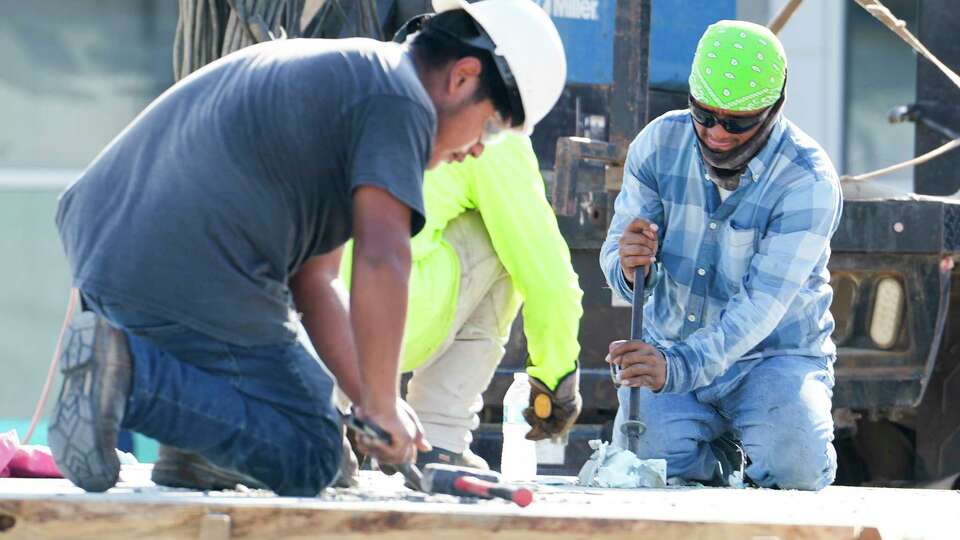 Men work on a concrete slab as construction on La Marketa de Porter continues, Tuesday, Sept. 5, 2023, in Porter. The 36,000-square-foot shopping center, slated to open by the end of 2023, will include a Teloloapan grocery store, Michoacan Seafood Restaurant, the Peruvian-Mexican restaurant 'Pollo Bravo,' as well as a bakery, medical office and laundromat.