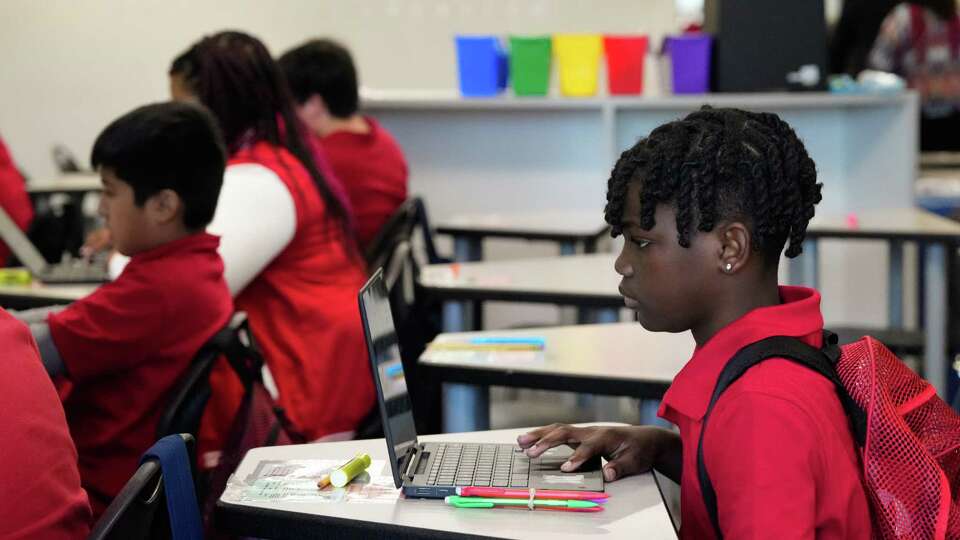 A Audrey H. Lawson Middle School student opens his laptop at the math team center Wednesday, Sept. 6, 2023 in Houston.