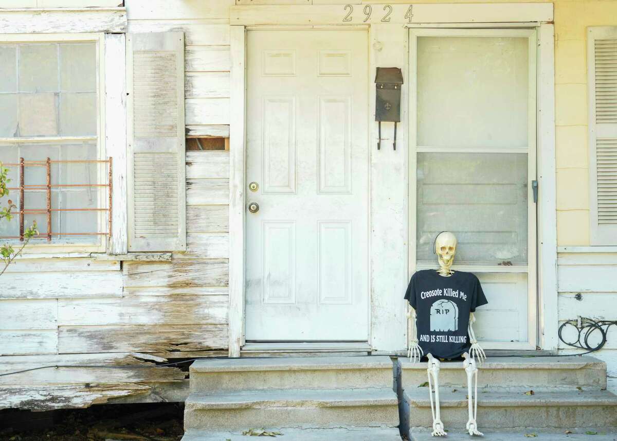 A plastic skeleton with a t-shirt that reads “ creosote killed me and is still killing” sits in from of the family home of Leisa Glenn, a Fifth Ward resident whose home is across from the former Southern Pacific rail yard, Friday, Sept. 8, 2023, in Houston. The site used creosote, a wood preservative the Center for Disease Control and Prevention says has been been shown to increase cancer, for decades prior to Souther Pacific’s takeover of the site in 1997, but a toxic plume of contamination remains underground. Glenn still maintains her family’s home on Lavender Street, but hasn’t lived in the family’s home full-time since 2005. “I stopped living there full time because I just don’t want to die of cancer like so many others,” she said.