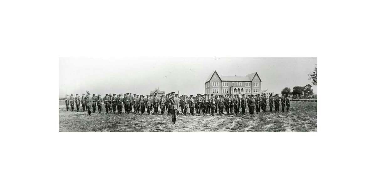 Cadets stand in formation at the Schreiner Institute in a mid-1920s photo. In the background are Dickey Hall, center; the Weir Building, then known as the Administration Building, right; and Hoon Hall, under construction at far right.