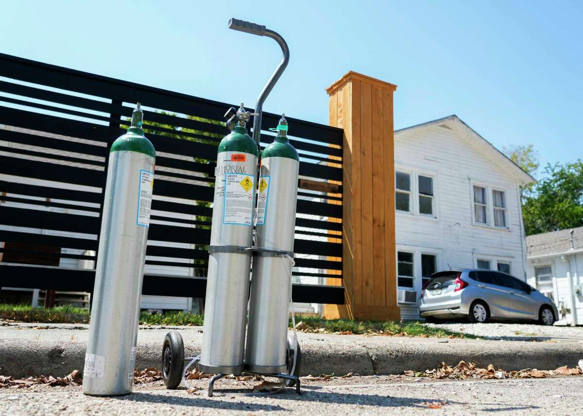 Oxygen takes that Barbara Beale used in her final months of life are seen on the side of the road near her home across from the Southern Pacific rail yard, Friday, Sept. 8, 2023, in Houston. Beale, who died from cancer on August 8, uses the tanks, connected to air tubes, to help her breath.
