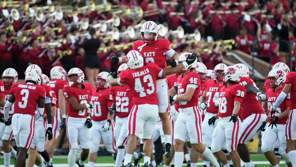 Katy running back Chase Johnsey (8) leaps into the air alongside running back Luis Trujillo (43) before a District 19-6A high school football game at Rhodes Stadium, Friday, Sept. 8, 2023, in Katy.