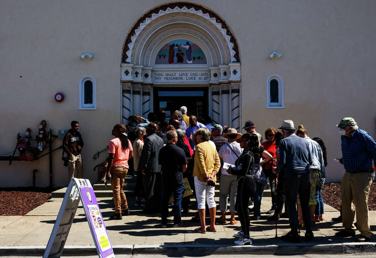 A crowd waits in line to attend a public safety presentation at Genesis Worship Center in Oakland. 