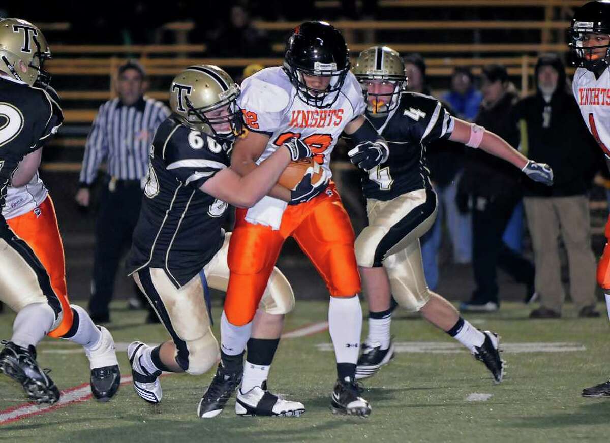 Stamford's Guarien Horton carries as Trumbull Bryan DeWalt (4) Brad O'Brien (68) are on defense as Trumbull High School hosts Stamford High School in Trumbull, CT on Friday, October 22, 2010.