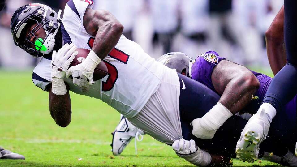 Houston Texans running back Dameon Pierce (31) is stopped by the Baltimore Ravens defense for a short gain during the first half of an NFL football game Sunday, Sept. 10, 2023, in Baltimore.