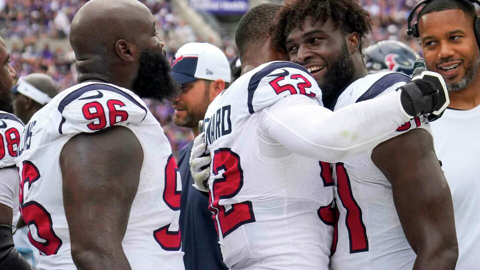 Houston Texans defensive end Jonathan Greenard (52) embraces defensive end Will Anderson Jr. (51) as he congratulates the rookie for his first NFL sack, as he brought down Baltimore Ravens quarterback Lamar Jackson (8), during the second half of an NFL football game Sunday, Sept. 10, 2023, in Baltimore.