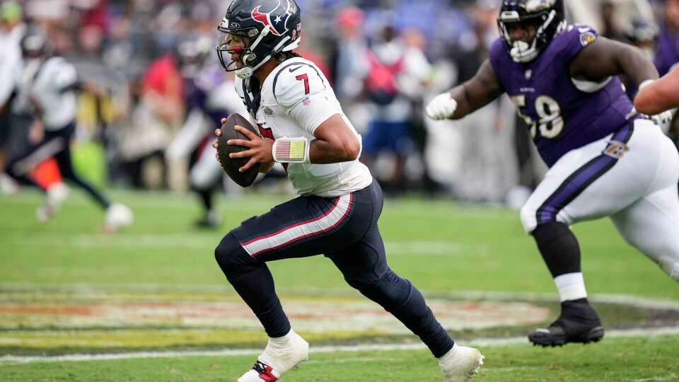 Houston Texans quarterback C.J. Stroud (7) is chased out of the pocket during the second half of an NFL football game Sunday, Sept. 10, 2023, in Baltimore.