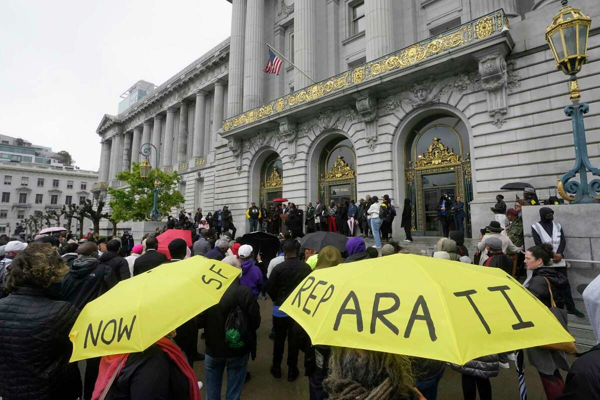 A crowd listens to speakers at a reparations rally outside of San Francisco City Hall in March. 