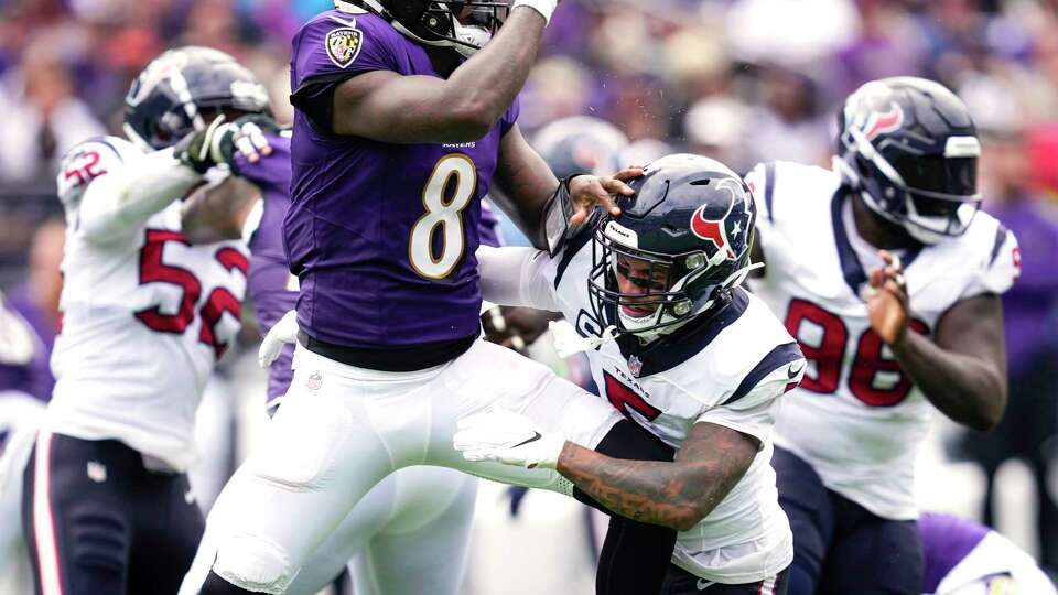 Houston Texans safety Jalen Pitre (5) appears to take a knee to the chest as he pressures Baltimore Ravens quarterback Lamar Jackson (8), who threw an incomplete pass on the play, during the first half of an NFL football game Sunday, Sept. 10, 2023, in Baltimore. Pitre left the game at the end of the first half with a bruised lung. He was hospitalized overnight in Baltimore.