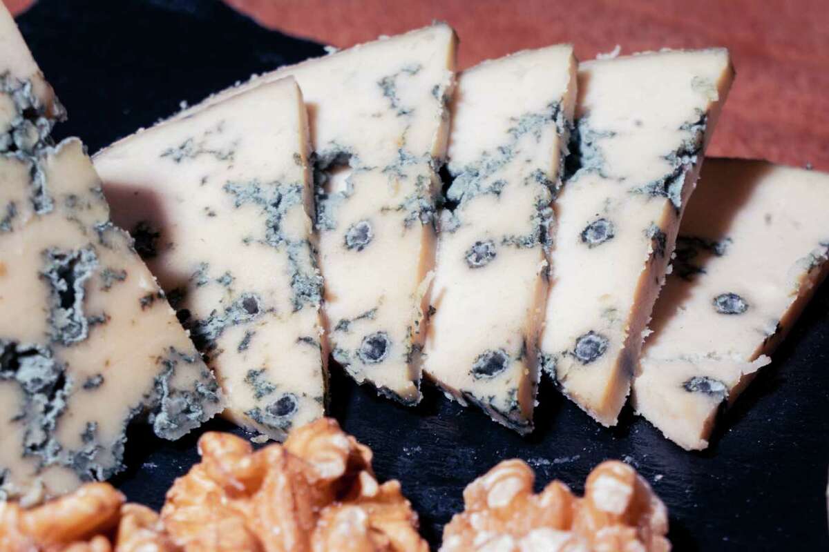 A wedge of blue cheese sits on a decorative plate as the first commercial product at Climax Foods headquarters in Berkeley, California on Friday, September 8, 2023. The breakthrough in vegan cheesemaking uses an AI model that gives the stretch properties of a conventional dairy cheese.