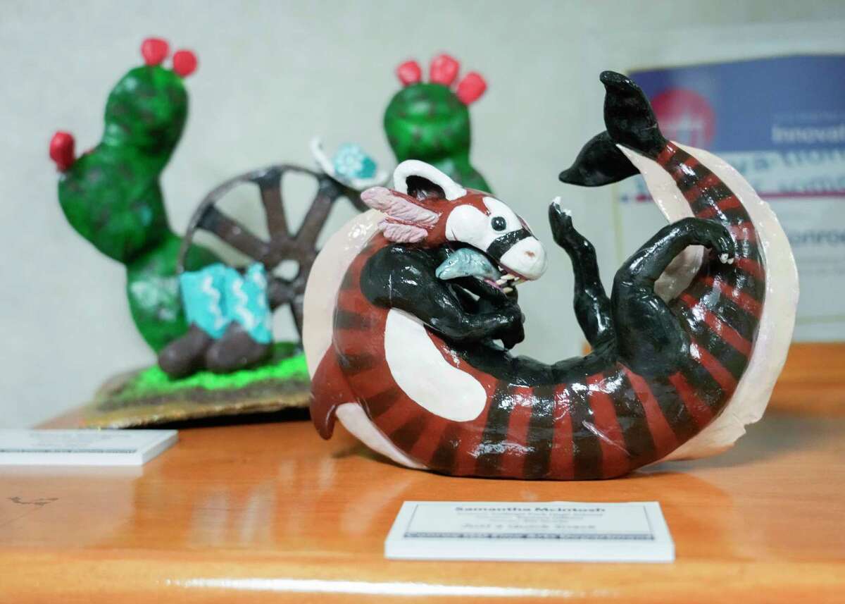 College Park High School freshman Samantha McIntosh piece entitled “Just a Quick Snack” is seen alongside more than 300 pieces of student art at the Deane L. Sadler Administration Building, Tuesday, Sept. 12, 2023, in Conroe. The art, which features paintings, sculptures and other mediums from kids in grades kindergarten through 12th grade, will be on display in the building from Sept. 15 through August 2024.