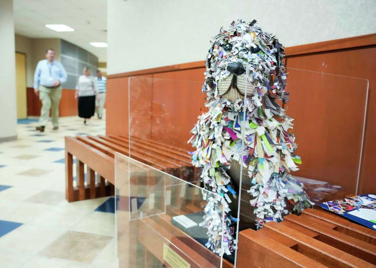 Grand Oak High School senior Lexie Reams’ piece entitled “Who’s A Good Boy” is seen alongside more than 300 pieces of student art at the Deane L. Sadler Administration Building, Tuesday, Sept. 12, 2023, in Conroe. The art, which features paintings, sculptures and other mediums from kids in grades kindergarten through 12th grade, will be on display in the building from Sept. 15 through August 2024.