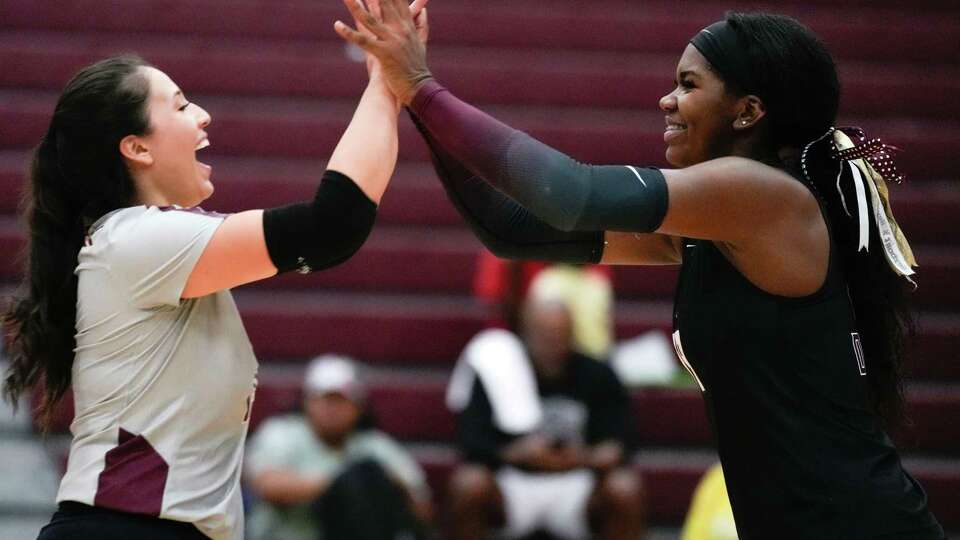 Summer Creek outside hitter Aspen Maxwell (19) gets a high-five defensive specialist Anika Frausto (15) from during the third set of a District 21-6A high school volleyball match at Summer Creek High School, Tuesday, Sept. 12, 2023, in Houston.