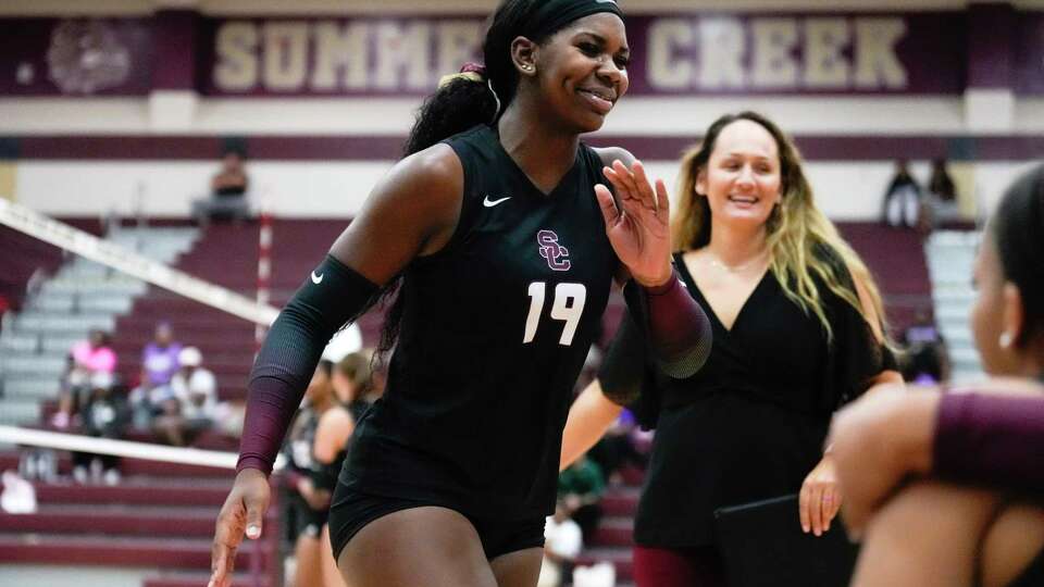 Summer Creek outside hitter Aspen Maxwell (19) reacts as she jogs to the bench in front of head coach Sarah Aguilar during the third set of a District 21-6A high school volleyball match at Summer Creek High School, Tuesday, Sept. 12, 2023, in Houston.