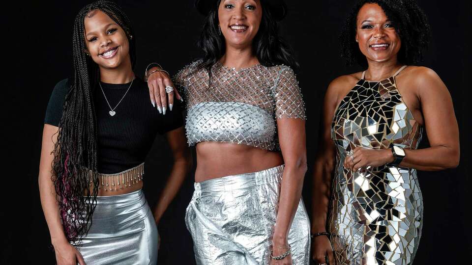 Beyonce fans, Ayden Campbell, left, Andrea Odom and LaQuishe Wright pose for a photo wearing silver on Tuesday, Sept. 12, 2023 in Houston. When Beyonce asked fans to wear silver to her Renaissance concerts, they began scooping up silver clothes and accessories online and in stores.