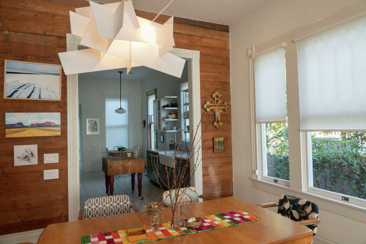 To celebrate the home's authenticity, they left the bare pine boards between the dining room and the kitchen exposed. 