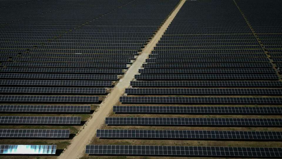 The sun beats down on Jake Dockins as he walks through a solar array Tuesday, Sept. 12, 2023, at the Blue Jay solar and storage plant in Iola.