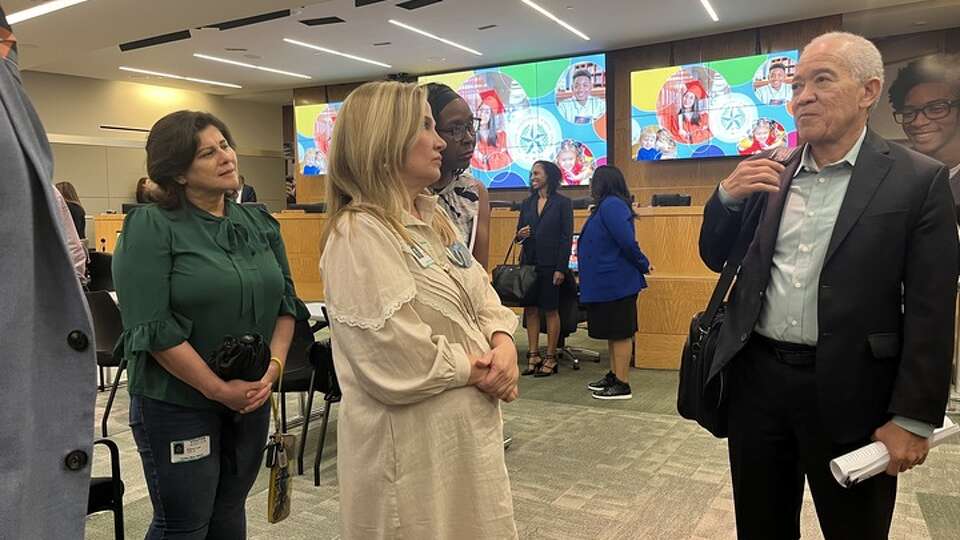 T.H. Rogers parents talk with Superintendent Mike Miles on Sept. 14, 2023, following the Houston ISD board's vote to uphold the previous administration's decision to keep a special needs program at the school. 