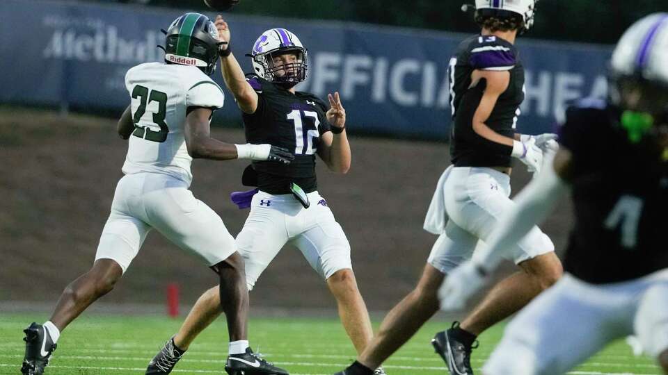 Fort Bend Ridge Point quarterback Austin Carlisle (12) throws a pass under pressure from Hightower linebacker Makhi Davis (23) during the first quarter of a District 20-6A high school football game at Edward Mercer Stadium, Thursday, Sept. 14, 2023, in Sugar Land.