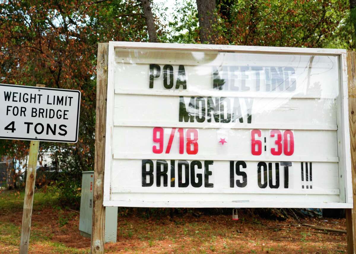 A sign in the Walnut Cove neighborhood of Willis notifies residents the bridge is out after it collapsed when a 30-ton concrete truck smashed through the beams Thursday morning while crossing, Friday, Sept. 15, 2023. The driver of the truck was not injured in the accident. The wooden bridge, near the intersection of Maywood and Sassafras streets, was constructed in 1987, and has a 4-ton weight limit, according to signs posted near the bridge.