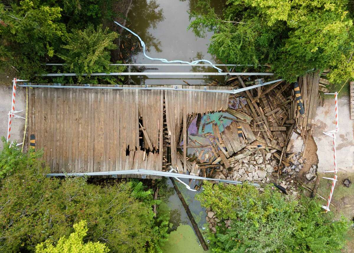 A wooden bridge in the Walnut Cove neighborhood of Willis is seen after it collapsed when a 30-ton concrete truck smashed through the beams Thursday morning while crossing, Friday, Sept. 15, 2023. The driver of the truck was not injured in the accident. The wooden bridge, near the intersection of Maywood and Sassafras streets, was constructed in 1987, and has a 4-ton weight limit, according to signs posted near the bridge.