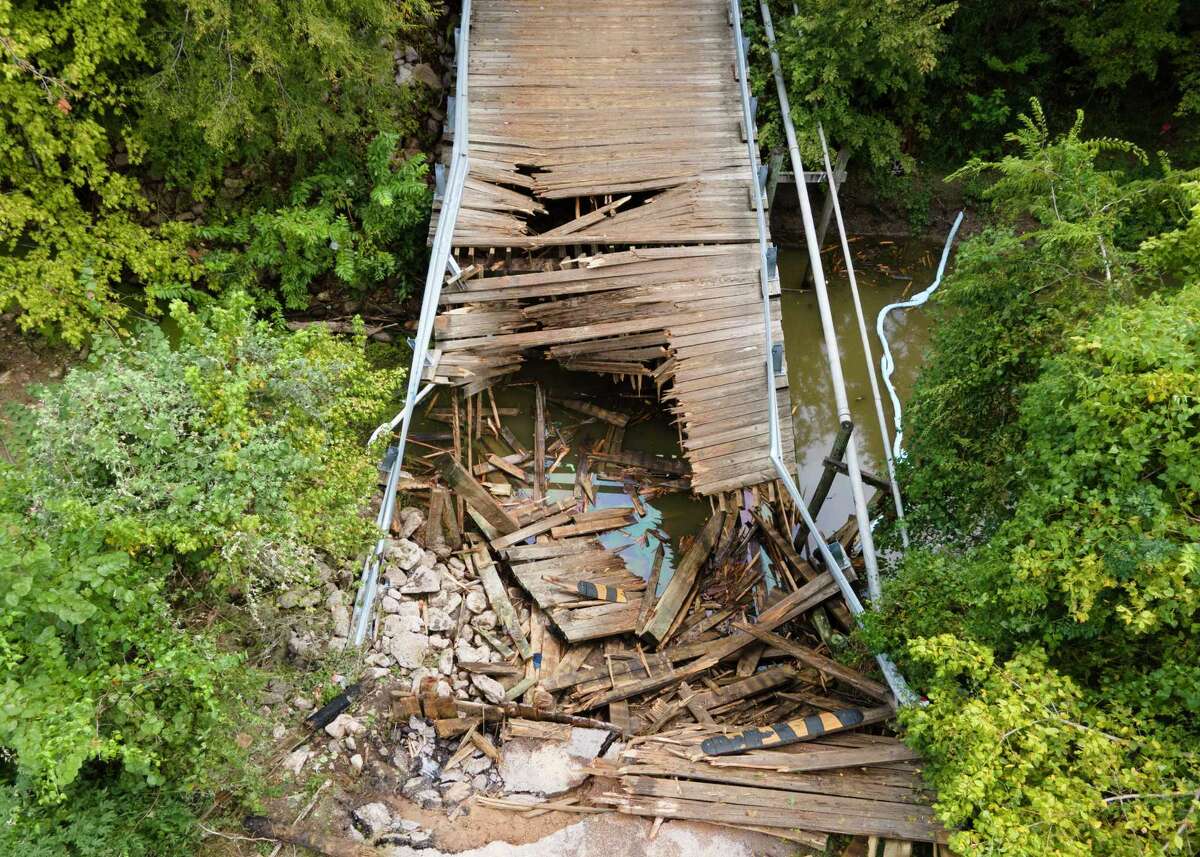 A wooden bridge in the Walnut Cove neighborhood of Willis is seen after it collapsed when a 30-ton concrete truck smashed through the beams Thursday morning while crossing, Friday, Sept. 15, 2023. The driver of the truck was not injured in the accident. The wooden bridge, near the intersection of Maywood and Sassafras streets, was constructed in 1987, and has a 4-ton weight limit, according to signs posted near the bridge.