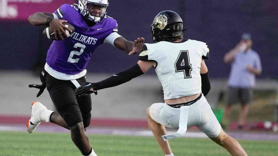 Willis' Derek Lagway (2) stiff-arms Conroe's Tate Trantham (4) during the first quarter of a District 13-6A high school football game at Berton A. Yates Stadium, Friday, Sept. 15, 2023, in Willis.