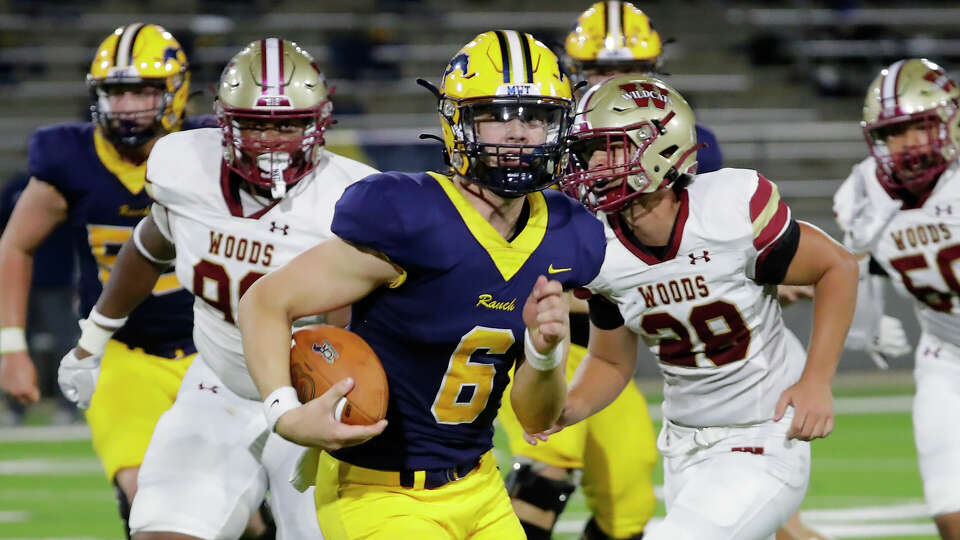 Cypress Ranch quarterback Owen Cossette (6) makes a gain on a keeper play in front of Cypress Woods defenders during the first half of their District 16-6A high school football game held at Cy-Fair FCU Stadium Friday, Sept. 15, 2023 in Cypress, TX.