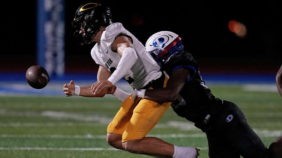 Klein Oak quarterback Lucas Sheerhorn fumbles the ball after being hit by Dickinson's Jeffery Mavon during the third quarter of a non-district high school football game at Sam Vitanza Stadium, Friday, Sept. 15, 2023, in Dickinson.