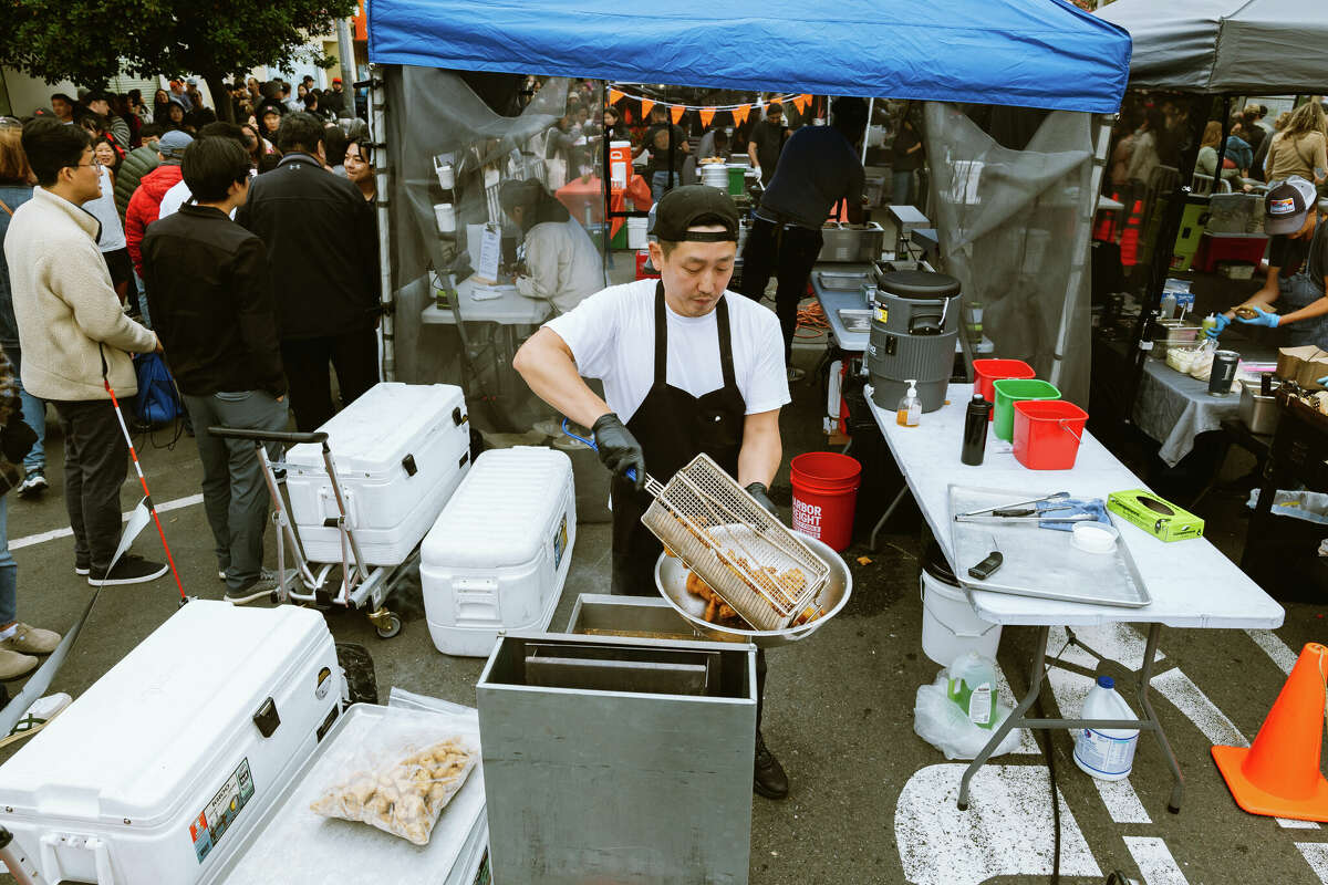 K-Pop Chicken chef Astro Park cooks at the Night Market in the Sunset District on Friday.