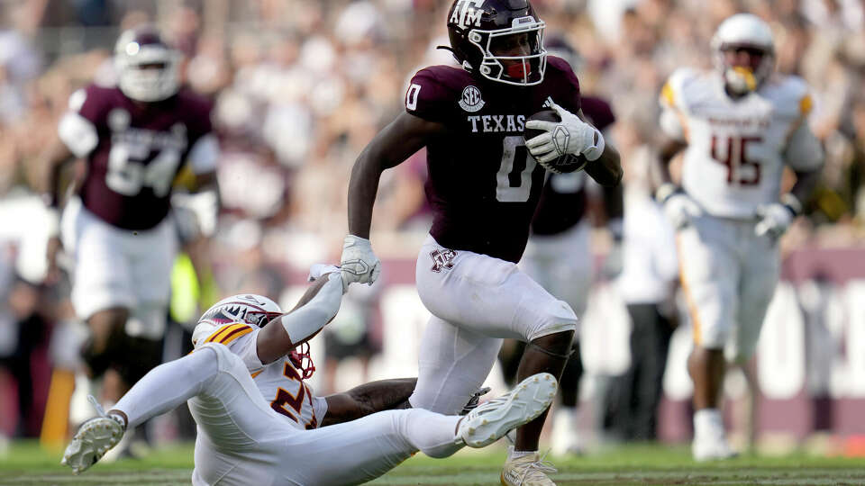 Texas A&M wide receiver Ainias Smith (0) breaks free from a tackle-attempt by Louisiana-Monroe linebacker Ja'Terious Evans, bottom left, to pick up a first down during the second quarter of an NCAA college football game Saturday, Sept. 16, 2023, in College Station, Texas. (AP Photo/Sam Craft)