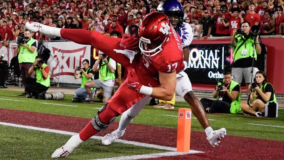 Houston Cougars tight end Mike O'Laughlin (17) catches a pass as TCU Horned Frogs safety Millard Bradford (28) defends during the second quarter of the University of Houston's inaugural Big 12 NCAA college football game at TDECU Stadium, Saturday, Sept. 16, 2023, in Houston. O'Laughlin's catch was ruled incomplete.