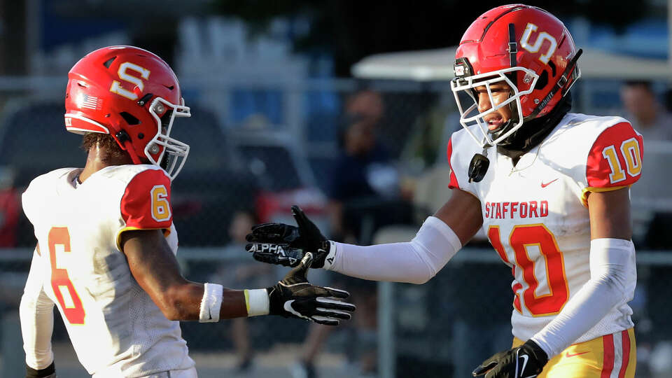 Stafford's Christian Getz (6) and Chris Holland (10) celebrate the touchdown by Holland against Lamar Consolidated during the first half of their non-district high school football game held Trayler Stadium Saturday, Sept. 16, 2023 in Rosenberg, TX.