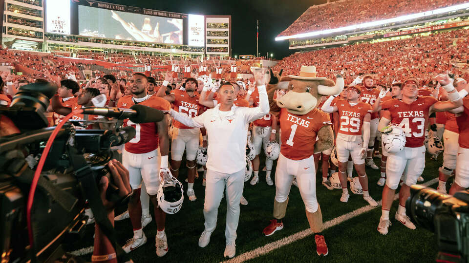 Texas coach Steve Sarkisian and his team sing 