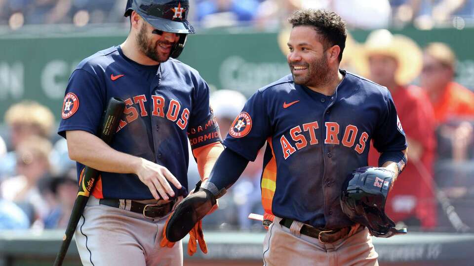 KANSAS CITY, MISSOURI - SEPTEMBER 17: Jose Altuve #27 of the Houston Astros is congratulated by Chas McCormick #20 after scoring during the 3rd inning of the game against the Kansas City Royals at Kauffman Stadium on September 17, 2023 in Kansas City, Missouri.