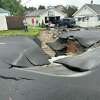 Workers arrive at the scene in Lansignburgh were a 30-inch water main blew, flooding parts of the neighborhood.