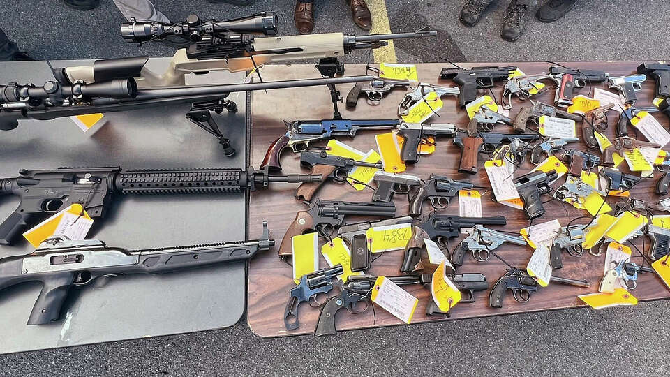 This photo, provided by the Office of New York Attorney General Letitia James, on Aug. 28, 2022 shows some of the 296 firearms, including 177 ghost guns, that were surrendered to law enforcement at a gun buy-back event hosted by her office and the Utica, NY, Police Department. The New York attorney general's office has tightened rules on gun buybacks after a critic of the policy boasted online about receiving $21,000 in gift cards for weapon parts made on a 3D printer. Buybacks are a popular way for government officials to try to get guns off the streets. But they can also attract people trying to demonstrate that buybacks are futile in the era of printable weapons. (Office of New York Attorney General via AP)