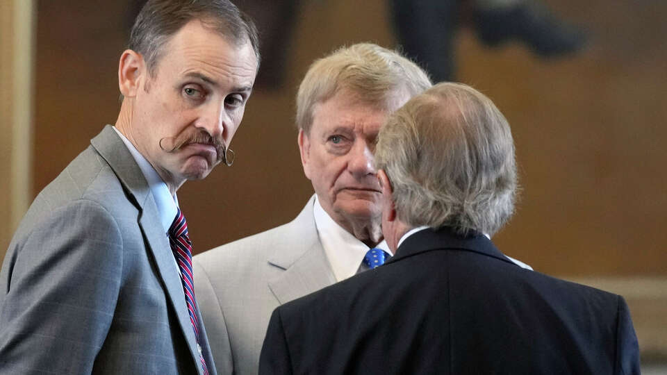House impeachment manager Andrew Murr talks with attorneys Rusty Hardin and Dick DeGuerin before the morning session of Texas Attorney General Ken Paxton's impeachment trial in the Texas Senate on September 6, 2023. (Bob Daemmrich/Pool for the Texas Tribune)