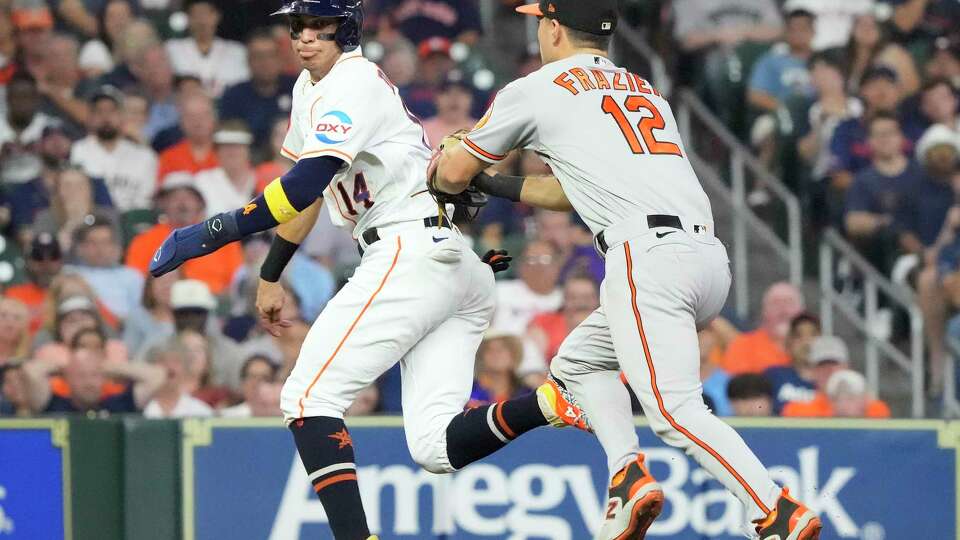 Houston Astros Mauricio Dubon (14) is tagged out on a rundown by Baltimore Orioles second baseman Adam Frazier (12) during the fifth inning of an MLB baseball game at Minute Maid Park on Tuesday, Sept. 19, 2023 in Houston.