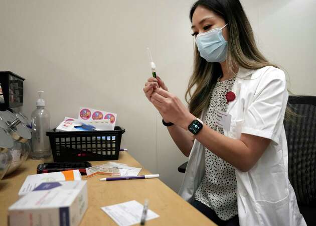 Kim Nguyen, pharmacist, prepares a flu vaccine at CVS, 12550 Louetta Rd., Wednesday, Sept. 20, 2023, in Cypress.