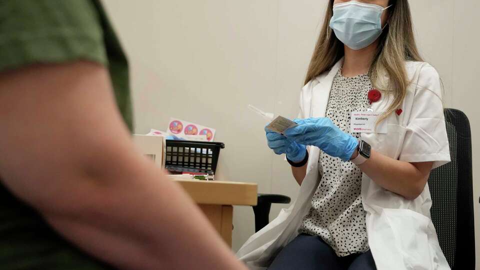 Kim Nguyen, pharmacist, prepares a Moderna Spikevax COVID-19 vaccine at CVS, 12550 Louetta Rd., Wednesday, Sept. 20, 2023, in Cypress.