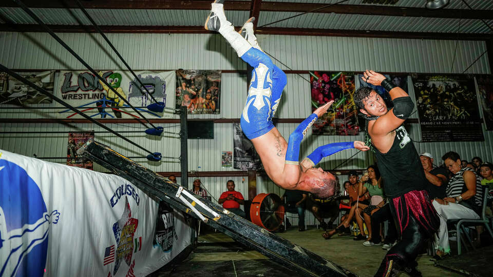 Luchadores wrestle during a Lucha Libre fight at Coliseo Houston 