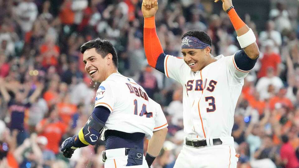 Houston Astros Mauricio Dubon (14) is mobbed by teammates including Jeremy Peña (3) after hitting a walk off RBI single to win an MLB baseball game at Minute Maid Park on Wednesday, Sept. 20, 2023 in Houston. Astros beat the Baltimore Orioles 2-1.