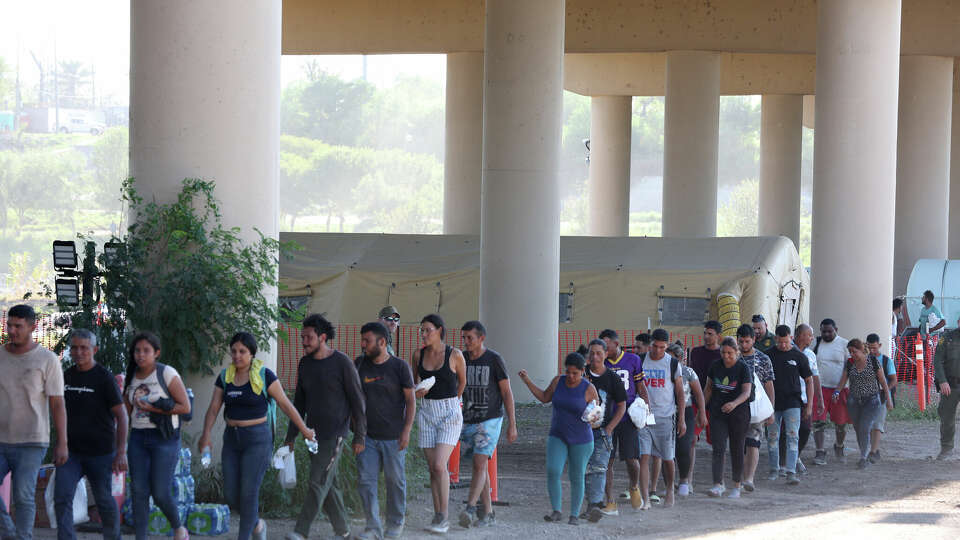 U.S. Border Patrol agents process hundreds of migrants under the International Bridge II in Eagle Pass, Texas, Wednesday, Sept. 20, 2023. A surge of migrants started early in the week leading to Customs and Border Protection to suspend vehicular processing operations on Bridge I to assist with the processing of the migrants.